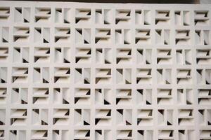 Geometric white wall pattern design with repeating square blocks and interior shadows for photo