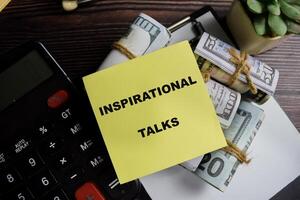 Concept of inspirational talks write on sticky notes isolated on Wooden Table. photo