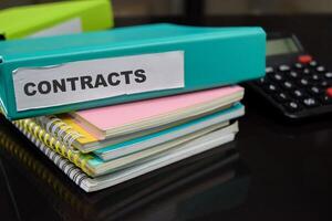 Folders with the label contracts. Business management concept photo