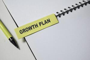 Concept of Growth Plan write on sticky notes isolated on Wooden Table. photo