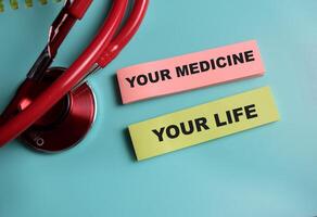 Concept of your medicine your life write on sticky notes isolated on Wooden Table. healthcare and pharmaceutical concept photo