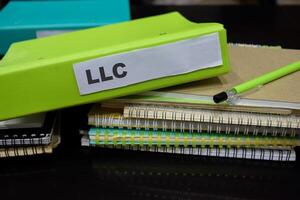 Folders with the label LLC. Business management concept photo