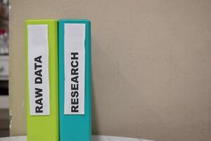 Folders with the label Raw data and research. Business management concept photo