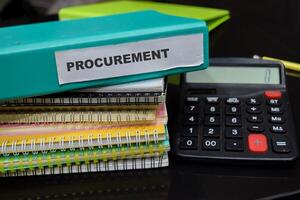 Folders with the label procurement. Business management concept photo