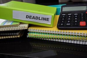 Folders with the label deadline. Business management concept photo