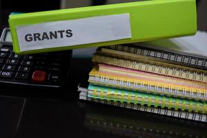 Folders with the label grants. Business management concept photo