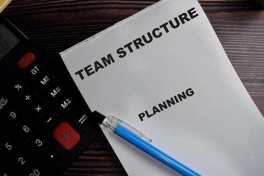 Concept of Team structure planning write on book isolated on Wooden Table. photo