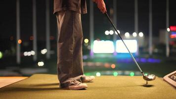 Person preparing to swing at driving range video
