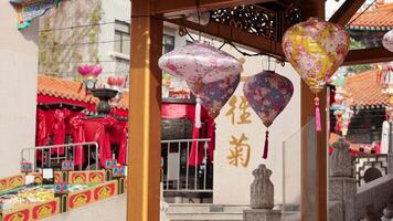 Vibrant lanterns sway at a traditional temple video