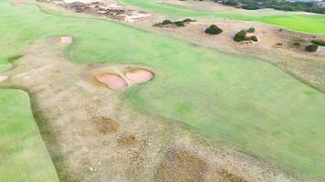Drone footage captures the expansive greens and coastal beauty of Barwon Heads, Victoria, under bright daylight video