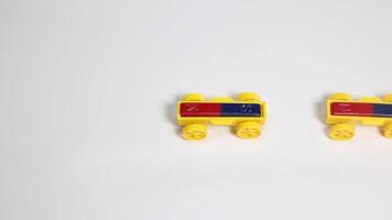 Hands manipulate magnetic toy cars on a white surface, illustrating magnetic attraction and repulsion in a well-lit environment video