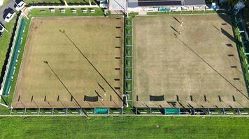 Drone footage captures a sunny day at a bowling green in Gold Coast, Australia, showcasing the field's layout and surrounding area video