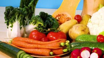 Assorted vegetables arranged on a blue background video