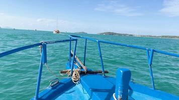 A serene boat ride over turquoise waters in Chalong Bay, Phuket, with clear skies and distant islands video