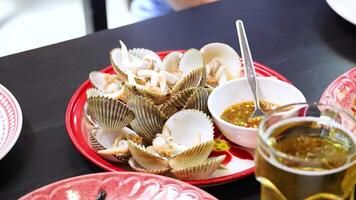 Enjoying boiled ark clams with spicy sauce in Phuket, Thailand video