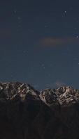 A serene night sky with stars above a snow-capped mountain range in Queenstown, New Zealand, under soft lighting video
