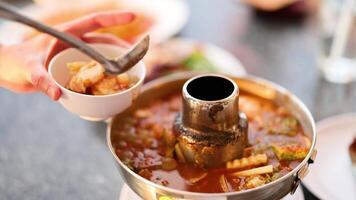 Ladling soup into a bowl at table video