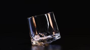 Ice cube dropped, glass tilts and stabilizes video