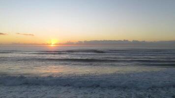 Calm ocean waves under a vibrant sunrise at Gold Coast, Australia. Soft lighting and serene atmosphere captured in a 14-second video