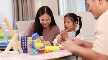 A family engages in creative play with clay, fostering learning and bonding in a warm, home environment video