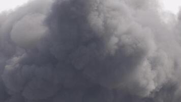 Thick, dark smoke clouds billow intensely, filling the frame with dynamic movement and dramatic atmosphere video
