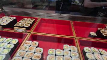 Various sushi types displayed and served video