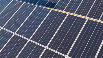Drone footage captures rows of solar panels in a sunlit field, highlighting renewable energy technology and sustainability video
