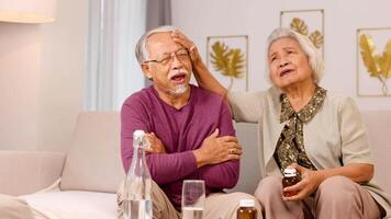An elderly couple in a cozy living room, showing care and concern. Warm lighting and intimate setting enhance the emotional connection video