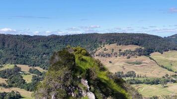 A sweeping view of Nimbin's lush hills and valleys under clear blue skies, captured in daylight video