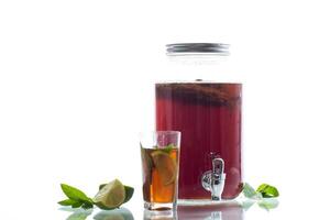 Refreshing kombucha in a glass jar and a glass with lime on white background photo