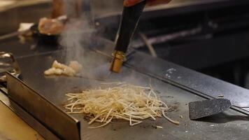 Chef expertly grills meat and vegetables. video