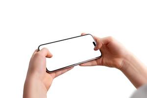 Close up of a smartphone held horizontally in a boy hands, focusing on the screen. Isolated display and background photo