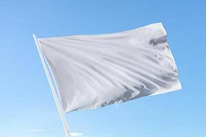 Soft white flag in motion against a blue sky, suitable for neutrality, announcements, or clean design with open space for text photo