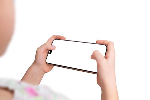 Close-up of a smartphone in a young girl's hands, held horizontally while interacting with a game or app. Isolated display and background, perfect for mockup photo