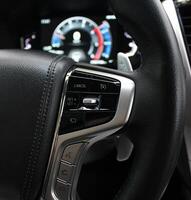 Defocused LED Dashboard Behind Steering Wheel With Control Buttons On It photo