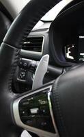 Gear shifter and headlight control lever under steering wheel of modern car photo