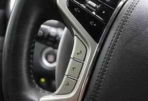 Touch control unit for the volume of the sound system and voice control on the steering wheel of the car photo