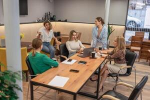 Teamwork meeting women, office, collaborate on project around table today, discussing business strategy. photo