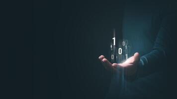 A man's hand shows an abstract virtual binary code hologram to symbolize the unification of control and encryption, protecting against cyber attacks. photo
