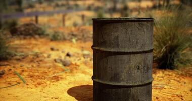 CGI old, empty, and rusted metal barrel in a sandy, arid environment. video