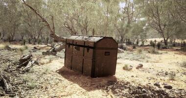 CGI weathered treasure chest situated in a dry, desert-like environment with sparse vegetation. video