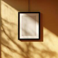 A picture frame hanging on a wall in front of a window photo