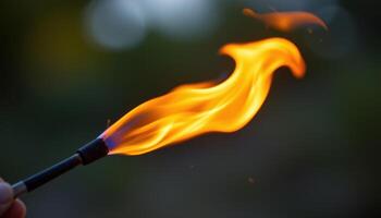 close up view of a flame caught mid motion in a gust of wind, bending dramatically to one side. photo