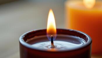 close up view of a flame hovering above a polished black candle wick just after ignition. photo