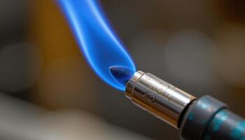 close up view of a blue flame emerging from a precision blowtorch nozzle. photo