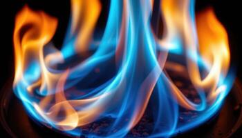 close up view of bright blue flame burning in complete darkness, glowing neon like. photo