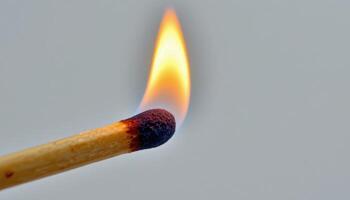 close up view of a small matchstick flame delicately consuming the wood tip, its vibrant glow highlighting the intricate texture of the matchstick's surface. photo