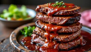 close up view of bbq meat tower stacked on rustic platter with sauce trickling down. photo