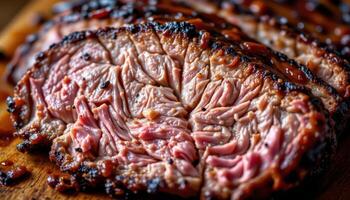 close up view of flame seared beef brisket sliced to reveal tender marbling and sticky barbecue glaze dripping down the edges. photo