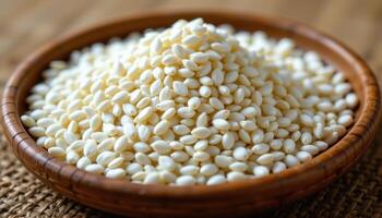 close up view of rice seeds in a delicate heap on a bamboo tray, with soft shadows and neutral background. photo